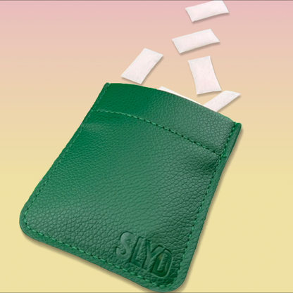 Green leather cardholder with 'Slyde' branding on a beige background